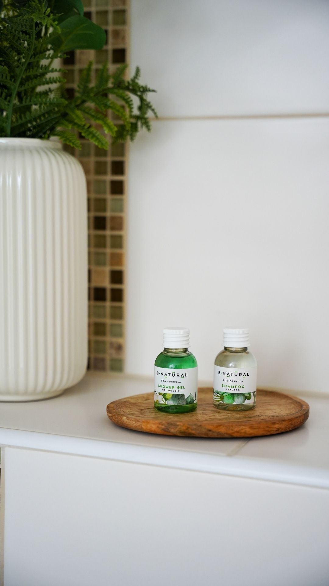 Two bottles of B-Natural eco formula products on a wooden tray.