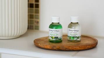 Two bottles of B-Natural eco formula products on a wooden tray.