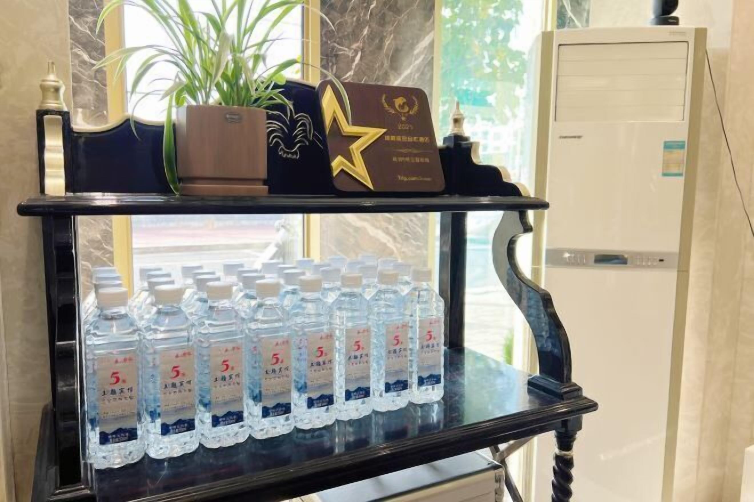 A shelf with bottled water and a decorative item.