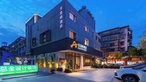 A modern hotel with a prominent 'A' logo on the facade, large windows, and a well-lit entrance. - Xiamen Aston Hotel (Zhongshan Road · Bailuzhou Park Branch)​ (Xiamen)