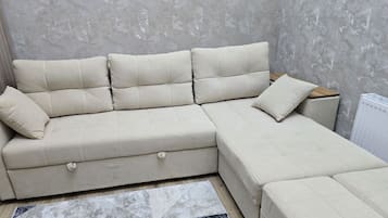 Deluxe Apartment, City View | Living area | Flat-screen TV