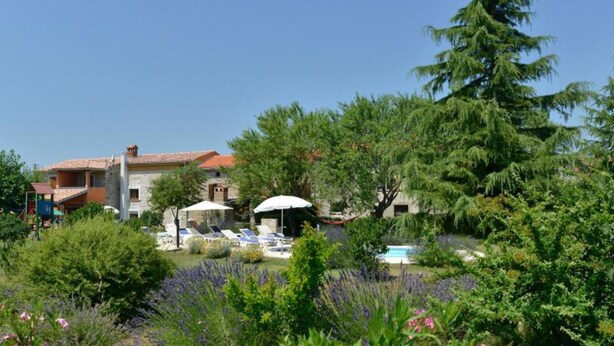 A villa with a pool, surrounded by lush gardens and a playground. - Authentic Istrian Holiday Home for Unforgettable Stays (Vodnjan)