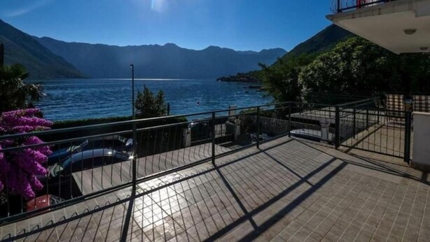 A balcony with a view of a lake and mountains. - Charming Seaside Escape in Kotor (Donji Stoliv)