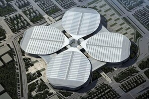 A modern building with a unique circular design, featuring a central open space surrounded by four large, curved structures. - Minhua Business Hostel (Shanghai)