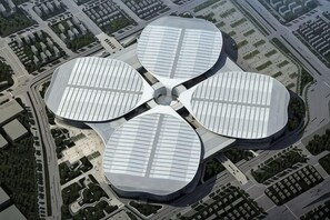 A modern building with a unique circular design, featuring large glass windows and a central open space. - Minhua Business Hostel (Shanghai)