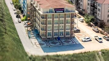 A multi-story building with a sign reading "KILICASLAN RESIDENCE".