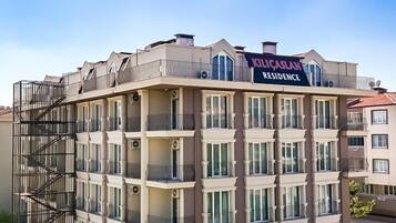 A multi-story building with a sign reading "KILICASLAN RESIDENCE".