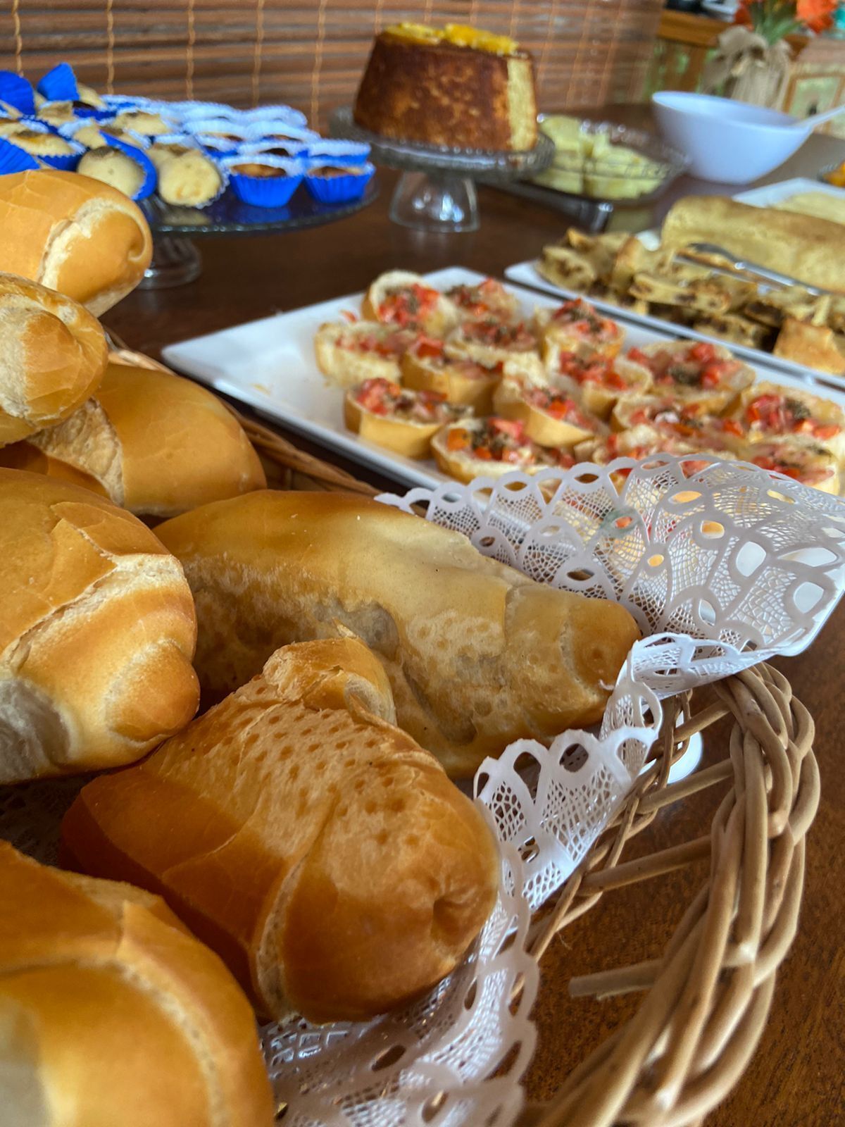 A variety of baked goods including bread rolls and pastries on a table.