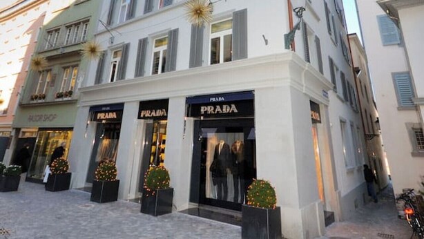 A multi-story building with storefronts including Prada.