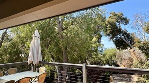 A covered outdoor seating area with a table and chairs, a white umbrella, and a view of trees and a clear sky. - Dunsborough Delight – Spacious Beachside Retreat in Old Dunsborough (Dunsborough)
