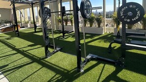 A gym with weightlifting equipment, artificial turf flooring, and large windows offering a view of the city. - Incredible new apartment in Centro Zapopan 304A (Zapopan)