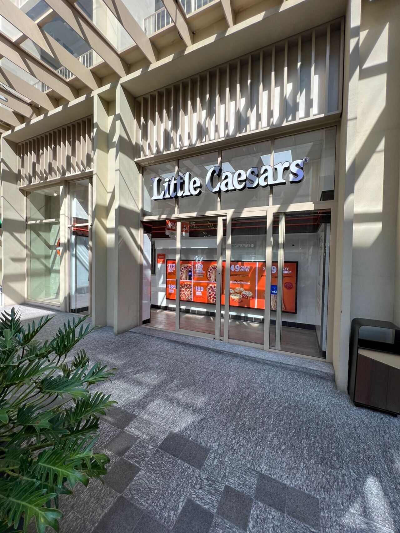 Little Caesars restaurant, moderne arkitektur, tydelig skilt og store glasfacade.