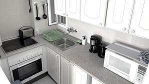 A kitchen with white cabinets, a stainless steel sink, a toaster, a coffee maker, and a microwave. - Ocean Panoramic View at Playa Las Americas (Playa de la Américas)