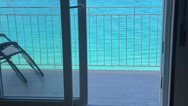 A balcony with a view of the ocean.