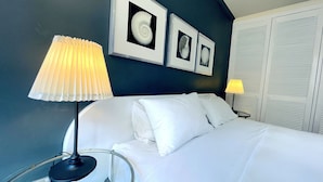 A neatly made bed with white linens, two wall-mounted lamps, and framed pictures above the bed. - Sydney CBD 2Bedroom Apartment (Sydney)