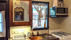 A kitchen with a wooden cabinet, a sink, a stove, and a microwave. - Crib house studio cabin - mountain views, .25mls to lake, quiet comfort! (Twin Lakes)