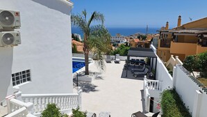 A rooftop pool area with a view of the sea, surrounded by buildings with Mediterranean architecture. - Ref: 281 Stunning villa with private pool (Fuengirola)