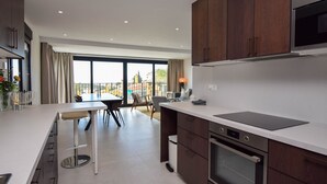 A modern kitchen with a large island, built-in oven, and a dining area with a view. - Ref: 281 Stunning villa with private pool (Fuengirola)