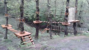 A forested area with wooden platforms, ropes, and ladders. - Holiday Home 'Casa Nuovissima' with Sea View, Wi-Fi and Air Conditioning (Praia a mare)