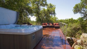 A hot tub on a wooden deck with outdoor seating and a railing. - Modern Santa Rosa Retreat Near Wineries & Trails (Santa Rosa)