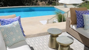 A poolside area with a view of the sea, outdoor furniture, and a large umbrella. - Modern Santa Rosa Retreat Near Wineries & Trails (Santa Rosa)