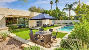 A backyard with a pool, outdoor furniture, and a patio area. - Private Pool + Putting Green: Sunny Scottsdale Gem (Scottsdale)