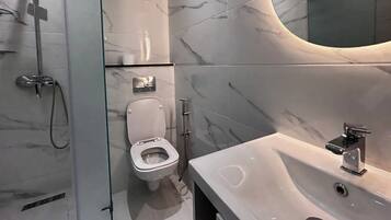 Shower, towels, soap, toilet paper