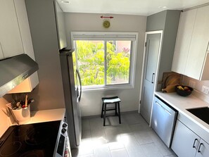 Fridge, stovetop, dishwasher, coffee/tea maker