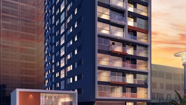 A modern high-rise building with multiple balconies, large windows, and a prominent entrance with glass doors. - Mini loft in front of malecon Bertolotto (minutes from Costa 21 and airport) (San Miguel)