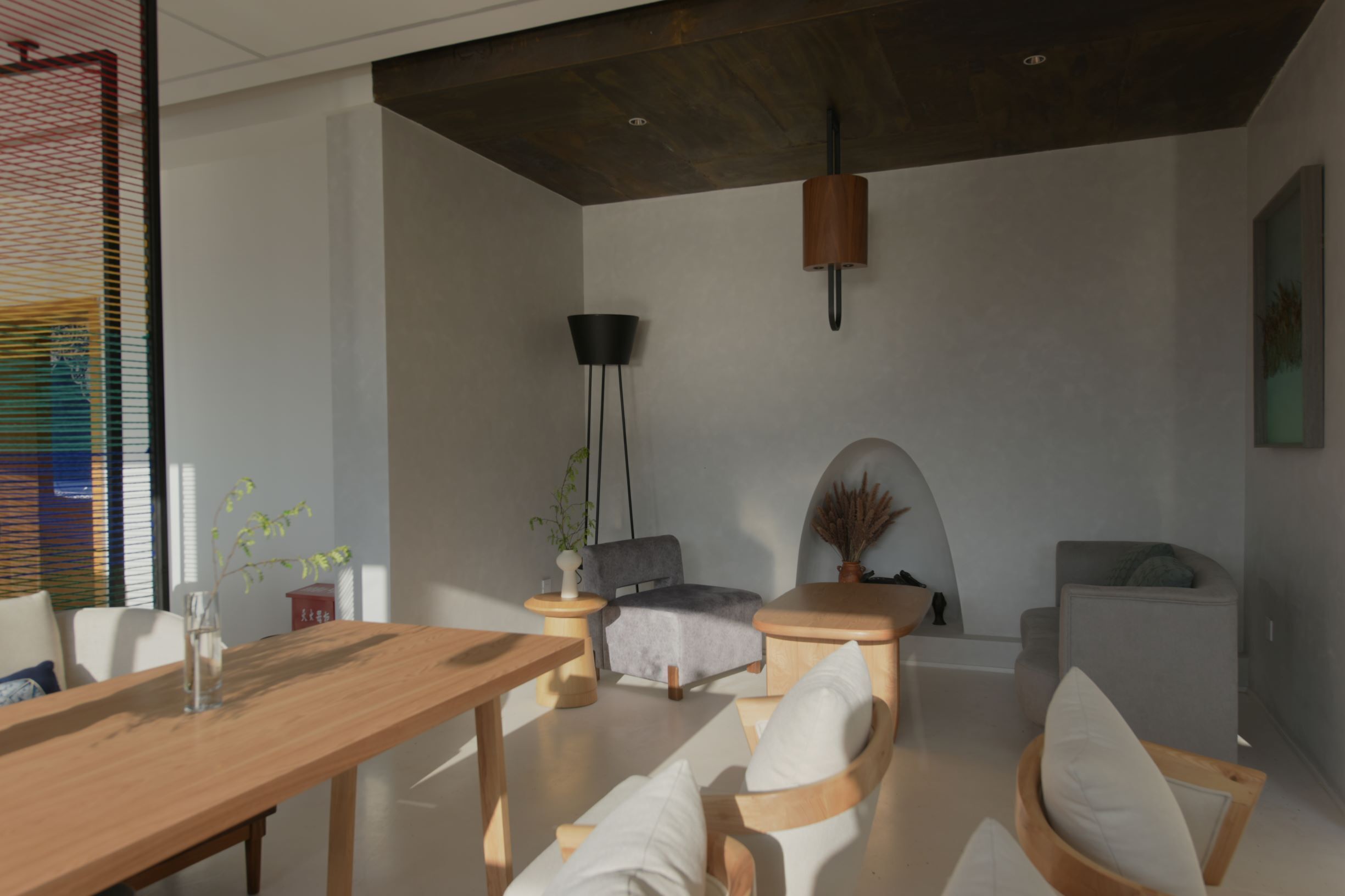 Una sala de estar moderna con una mesa de comedor de madera, sofás grises y una lámpara de pie negra.