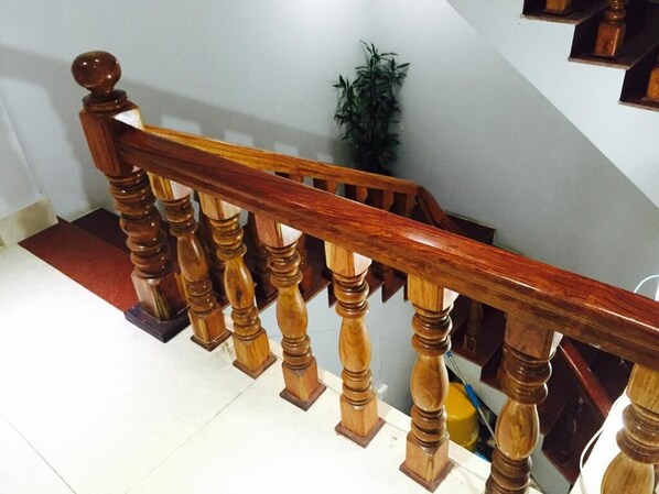 A wooden staircase with a handrail and balusters. - The Blue Hostel (Battambang)