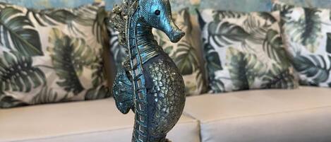 A seahorse figurine on a white table.