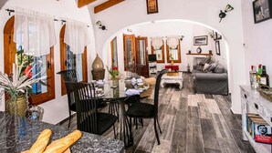 A cozy interior with a dining area, a sofa, and a kitchen area. - Serene Stay in Benissa (Benissa)