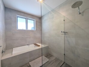 Een douche, handdoeken, zeep, toiletpapier
