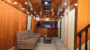A lobby with a sofa, a small table, and a reception desk.