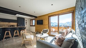 A modern living room with a sofa, chairs, and a dining area. - Sylodges 202 - Spacious apartment for 10/12 people (LA TOUSSUIRE)