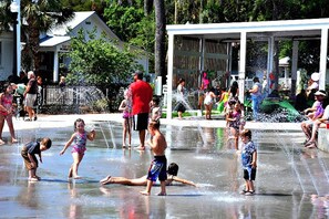 A water play area with children and adults enjoying the water. - Waterfront Angler’s Paradise, 3BR/2.5BA w/ Dock, Boat Ramp, Kayaks, HorseShoes, CornHole, Ping Pong (New Port Richey)