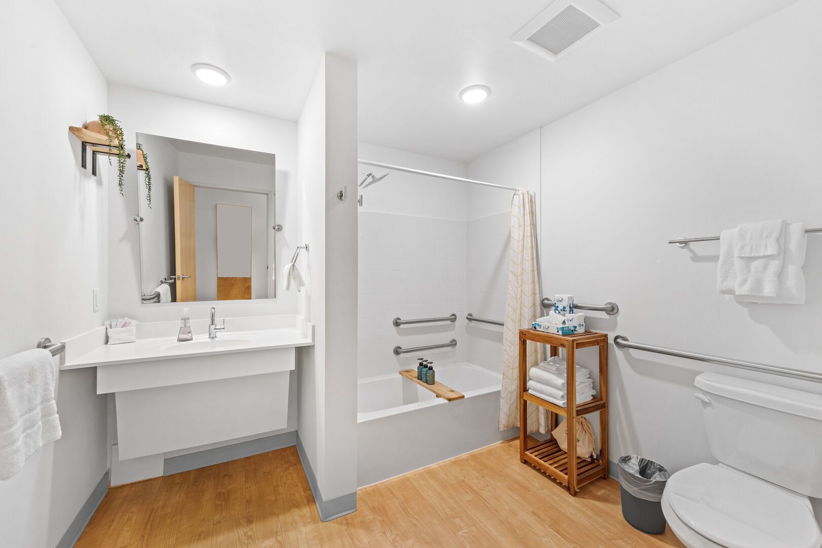 A modern bathroom with a shower, toilet, and sink.