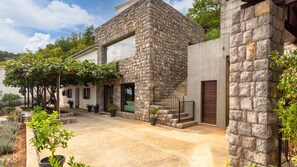 A stone building with a large window, a door, and a staircase. - Villa View Kvarner in Opatija by Villas Guide (Icici)