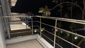 A staircase with metal railings leading to a balcony with a glass barrier. - LA MILLIONAIRE LUXURY RESORT (Vanur)