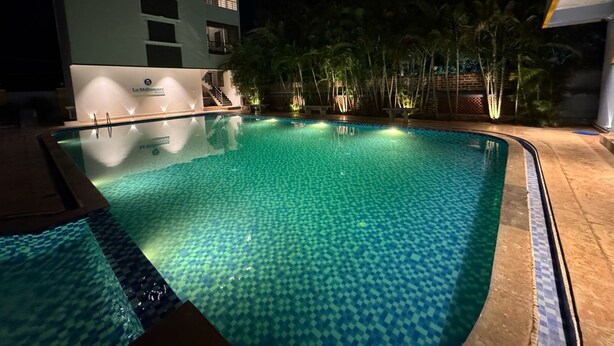 A swimming pool at night with a building in the background. - LA MILLIONAIRE LUXURY RESORT (Vanur)