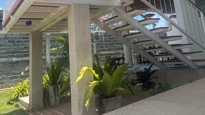 A modern building with a glass and metal staircase leading to an upper level. - Bunkhouse Koh Phangan (Ko Pha-ngan)