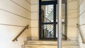 A staircase with marble steps and a geometric tile floor.