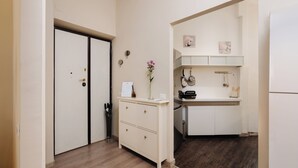 A modern kitchen with white cabinets, a built-in oven, and a small countertop. - Stylish 2-Bedroom Flat by St. Peter’s – King Bed, A/C, Fast Wi-Fi. Super Clean! (Roma)