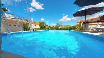 Seasonal outdoor pool, pool loungers