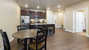 A modern kitchen with dark wood cabinets, stainless steel appliances, and a granite countertop.