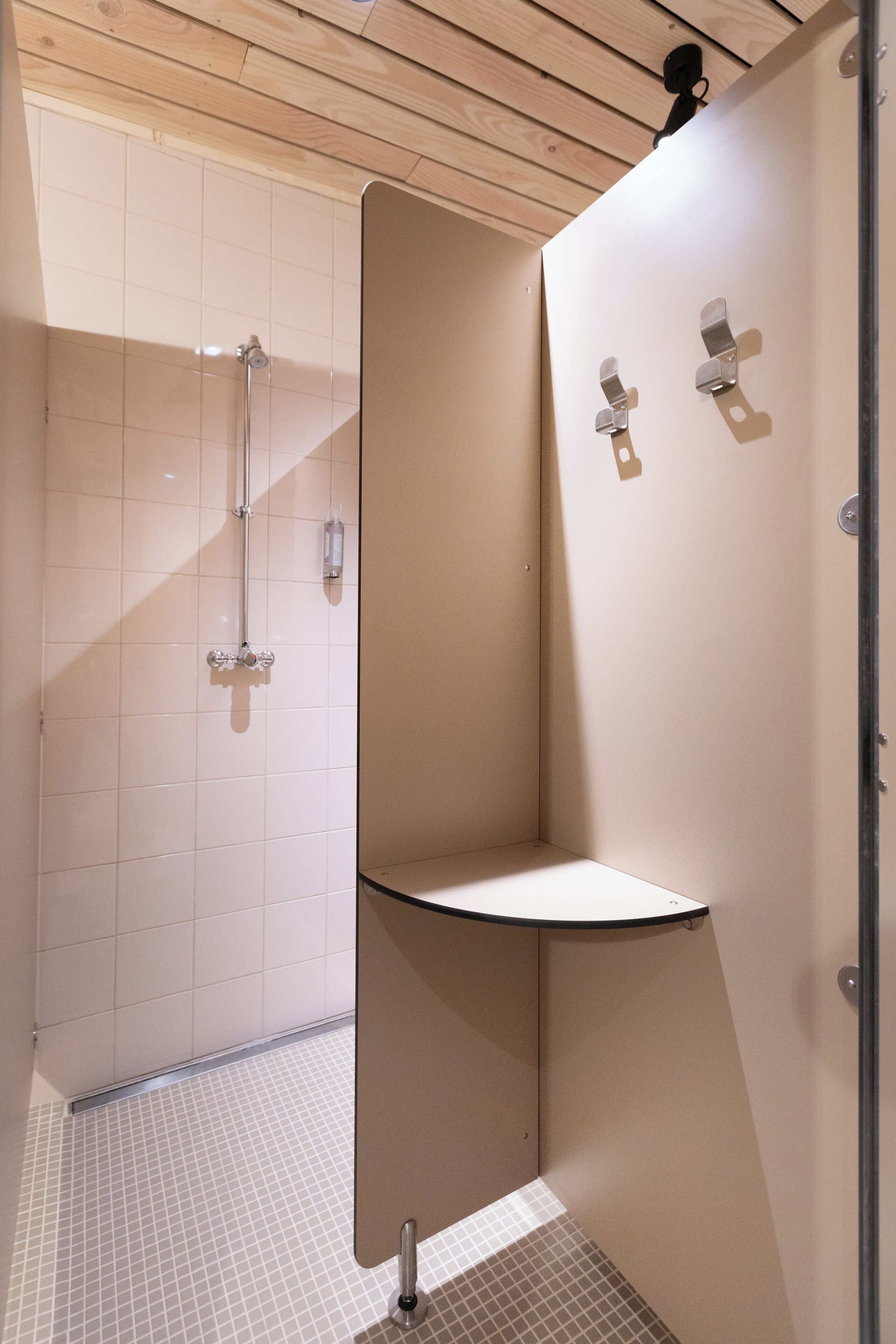 A modern bathroom with a shower, a sink, and a toilet.