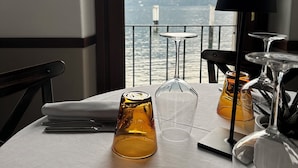 A table set for dining with a view of mountains and water. - Hotel La Pergola  (Bellagio)