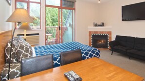 A room with a bed, a table with a remote control, a sofa, a fireplace, and a TV on the wall. - Village Studio at Alpenglow. Steps away from everything.
Pool and hot tub (Whistler)