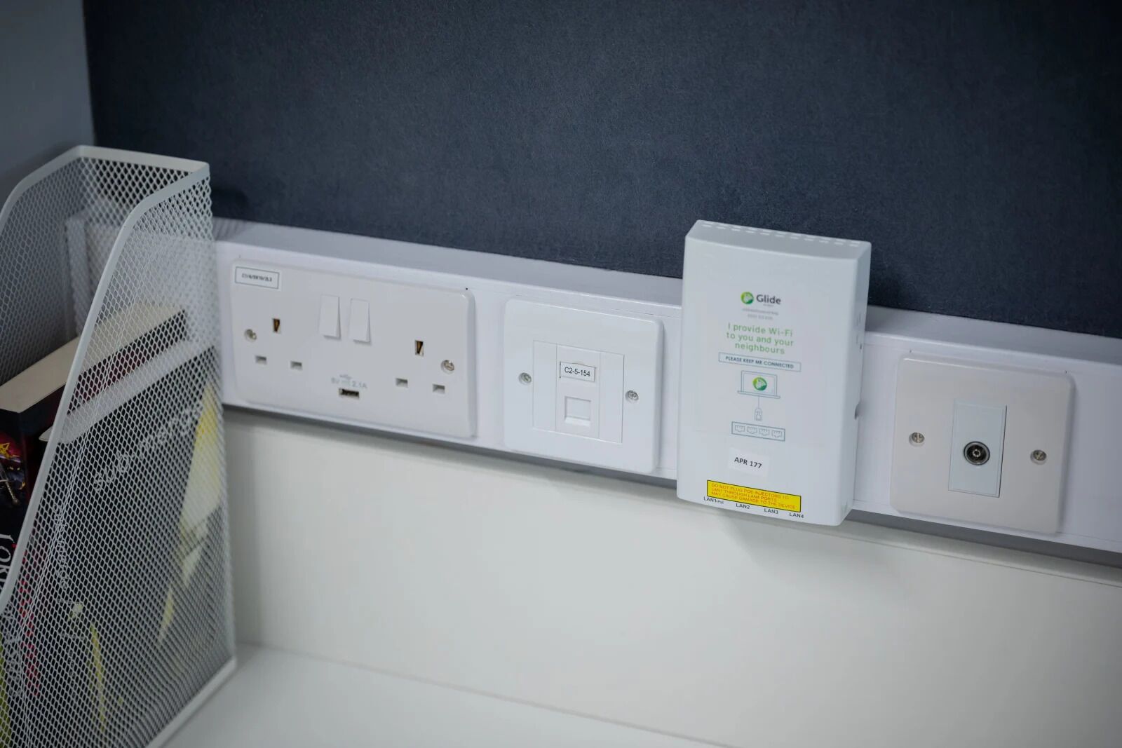 Une prise électrique murale dotée d’un tableau de distribution blanc et d’une boîte électrique blanche avec une étiquette.